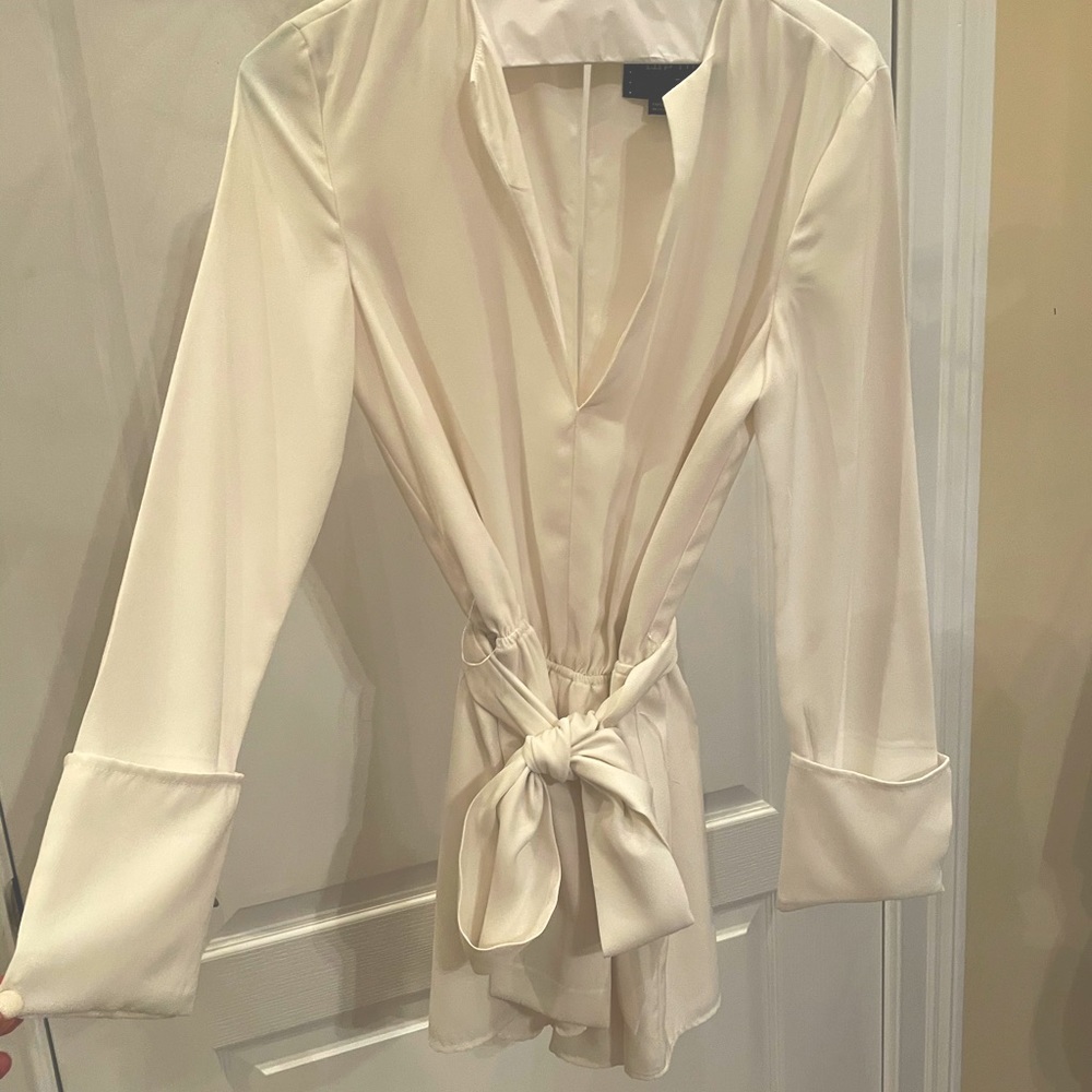 White, long sleeve short romper.